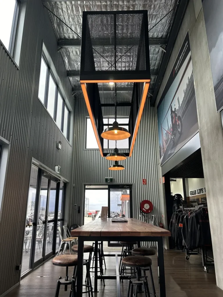 Modern industrial cafe with large windows and stools