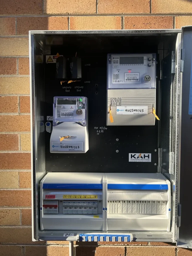 Electrical meter box on brick wall.