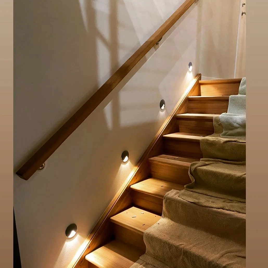 Wooden stairs with side lights and carpet runner