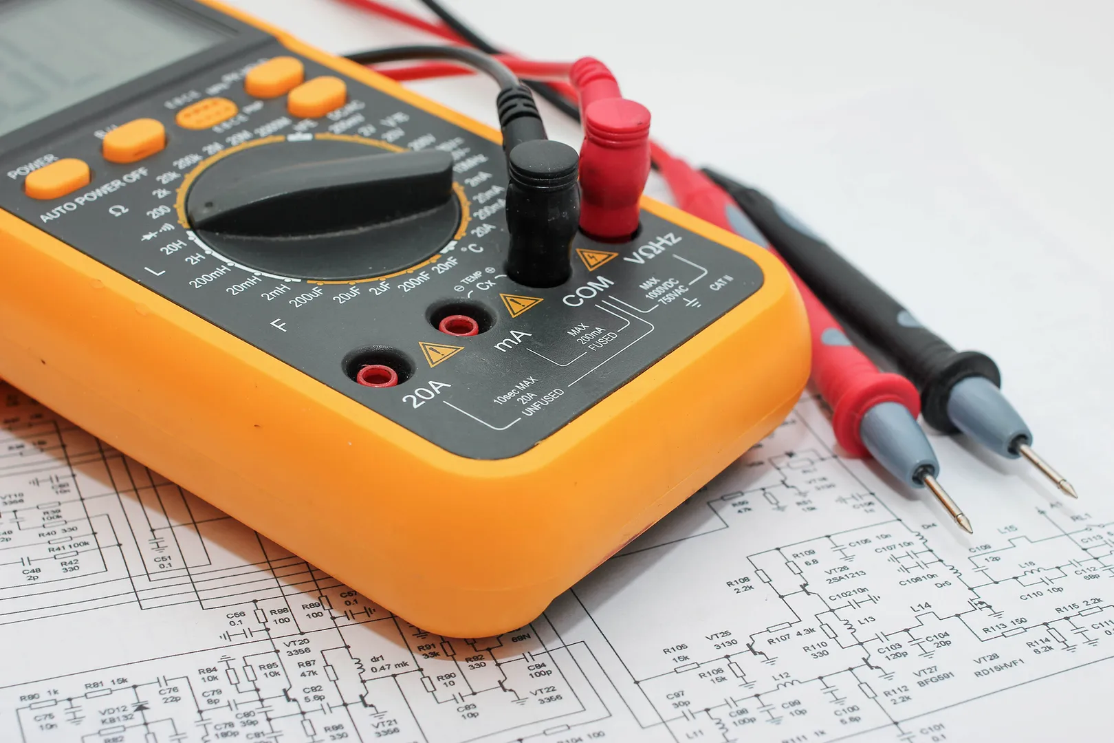 Digital multimeter on electronic circuit diagram